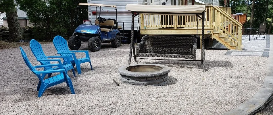 Chairs and swing next to a fire pit in Norwich, CT.