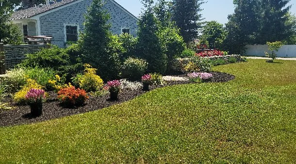 Lawn with colorful landscaped garden in Groton, CT.