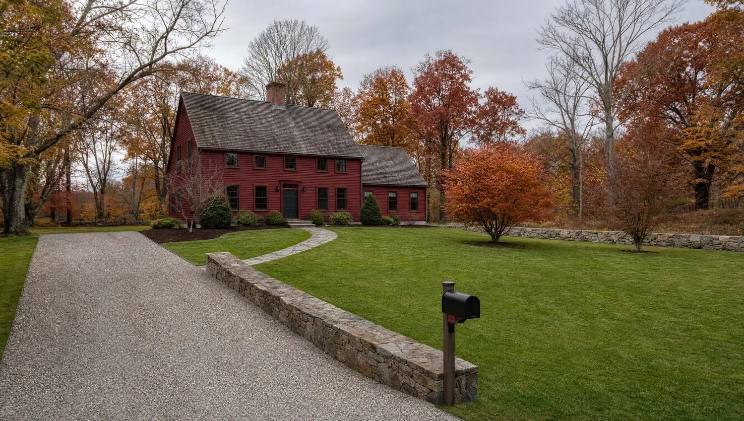 Fall cleanup finished at a red saltbox farmhouse in Connecticut with every leaf cleared