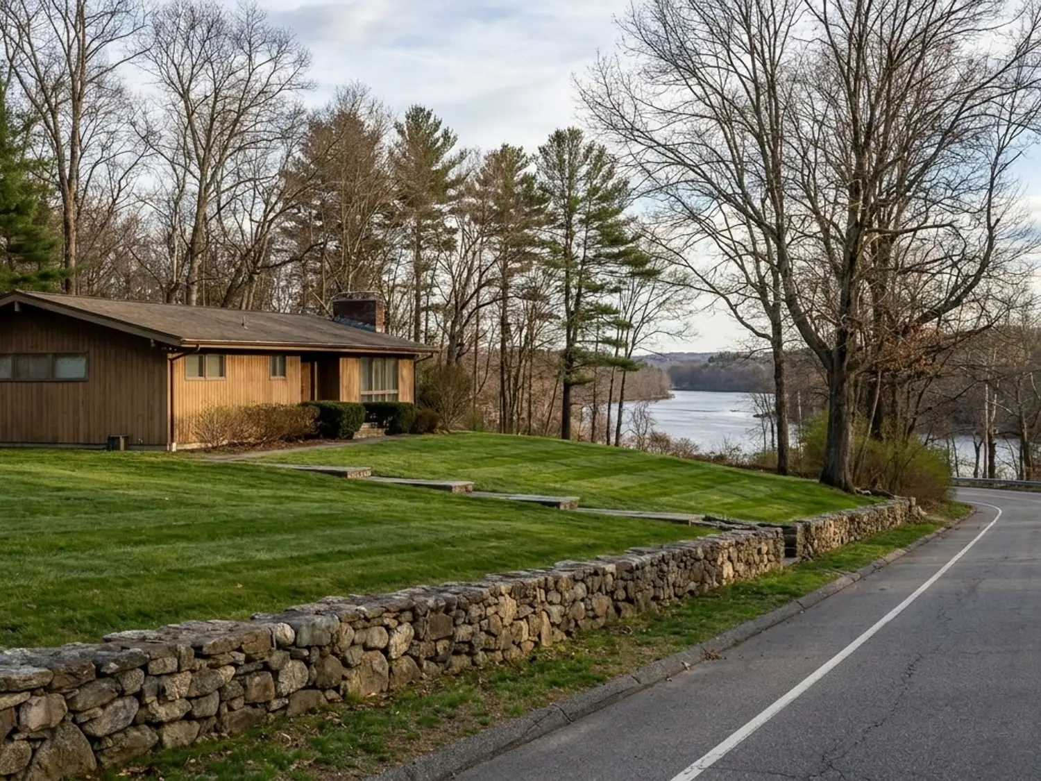 Terraced mown lawn on a sloping Gales Ferry CT house lot