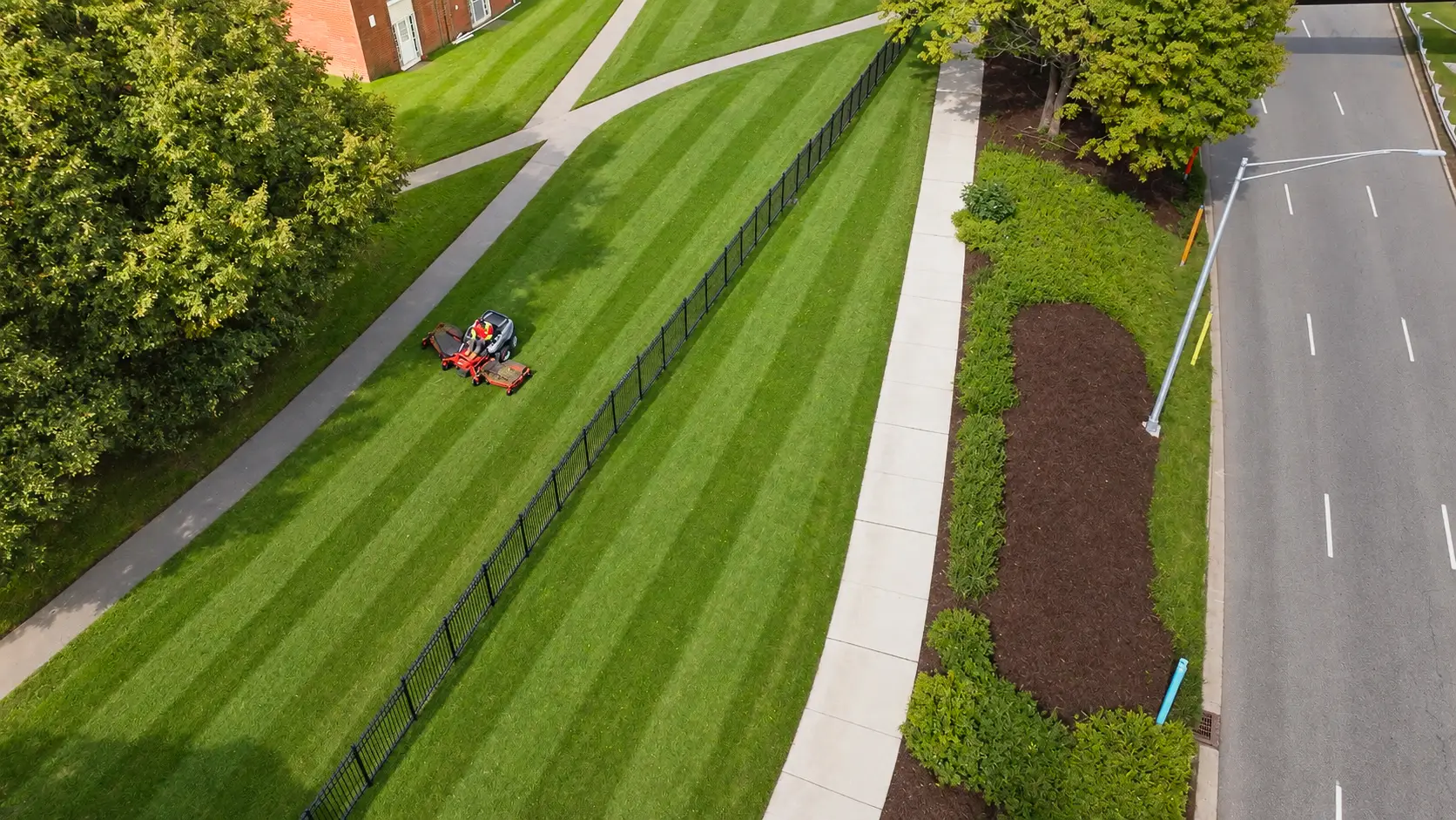 Striped lawn and clean beds on a property maintained by AGSM in southeastern CT