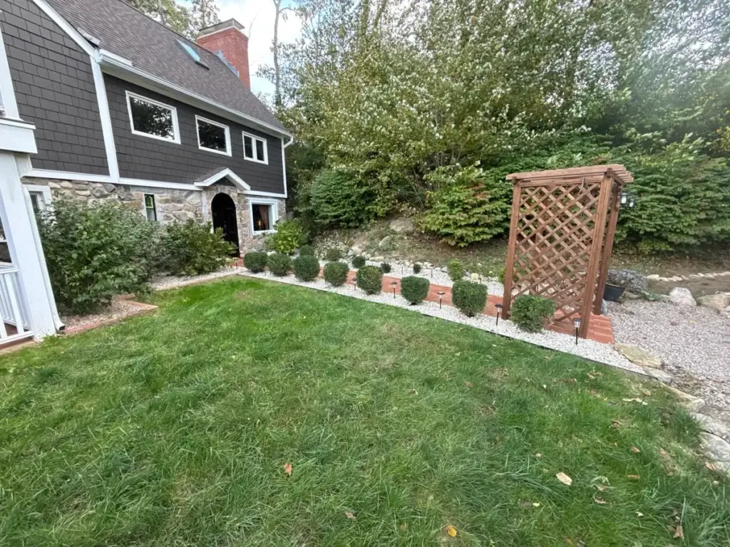Crisp bed edge with trimmed shrubs along the lawn in Stonington, CT