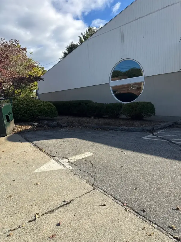 Commercial shrub bed trimmed and cleared along a parking lot in Groton, CT