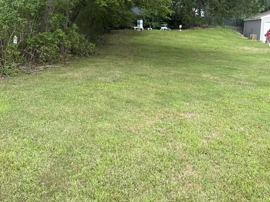 Long mowed backyard lawn on a weekly lawn care route in New London CT